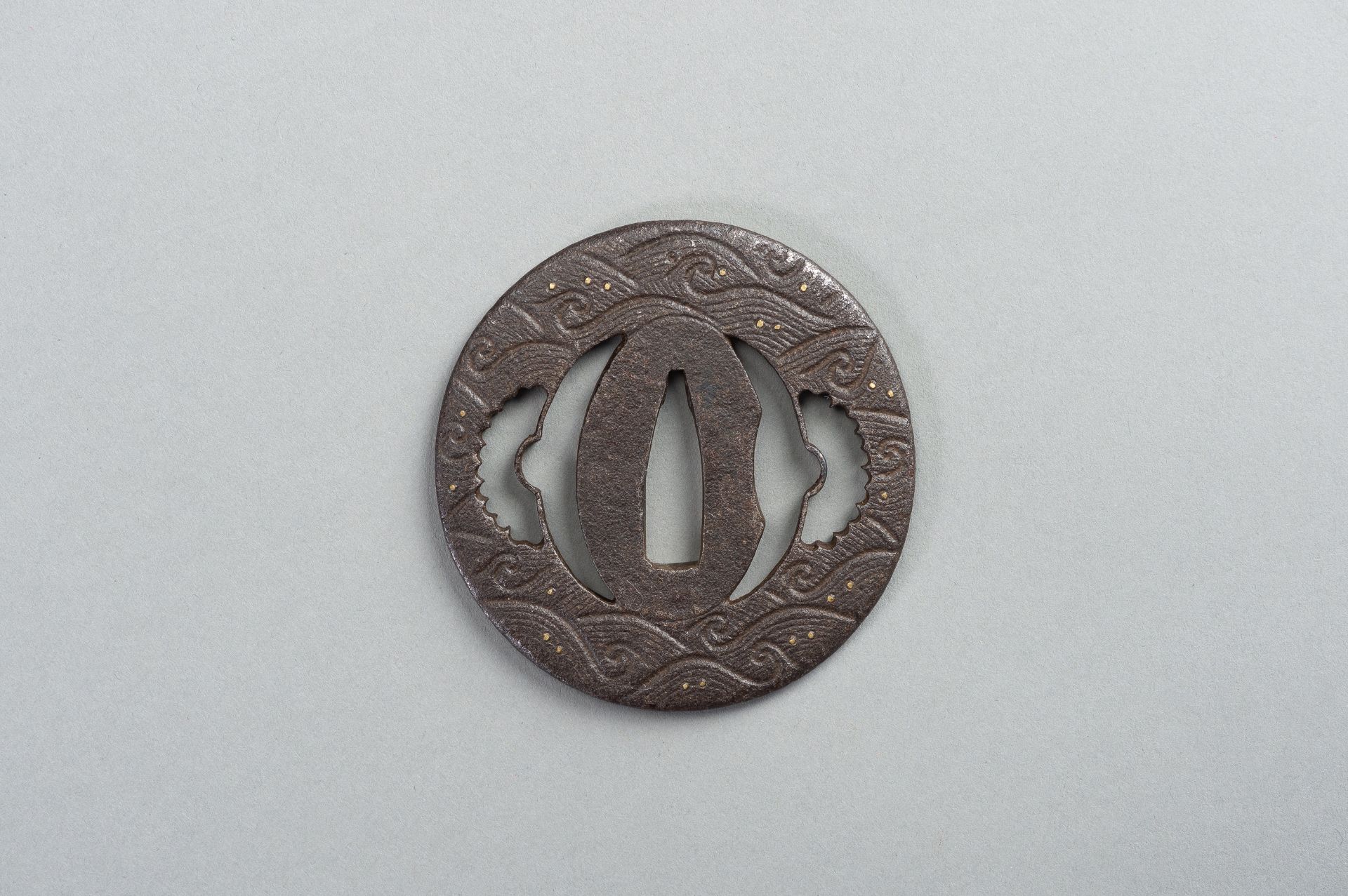 AN IRON SUKASHI-TSUBA WITH WAVES