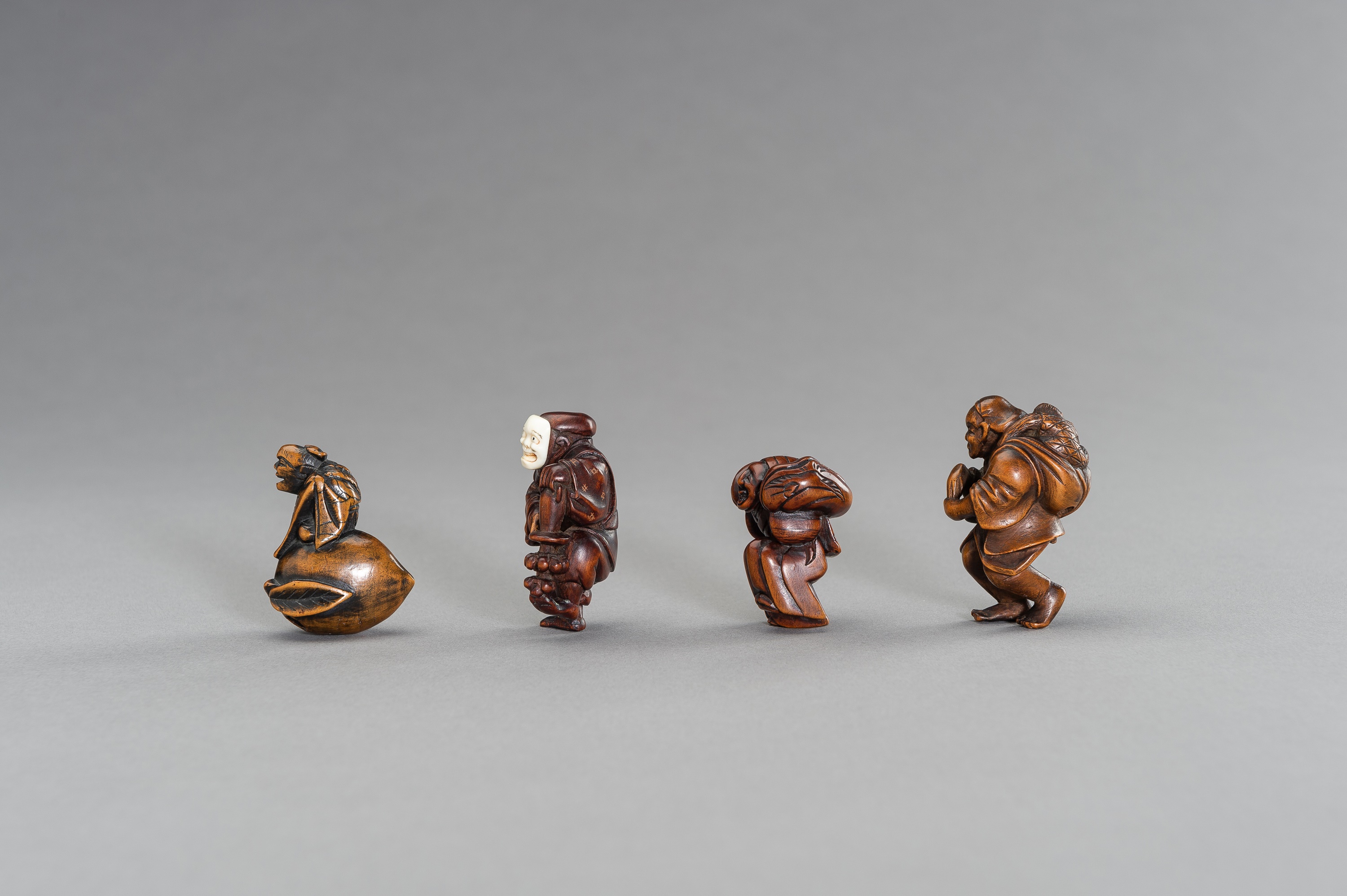 A GROUP OF FOUR FIGURAL WOOD NETSUKE - Image 2 of 3