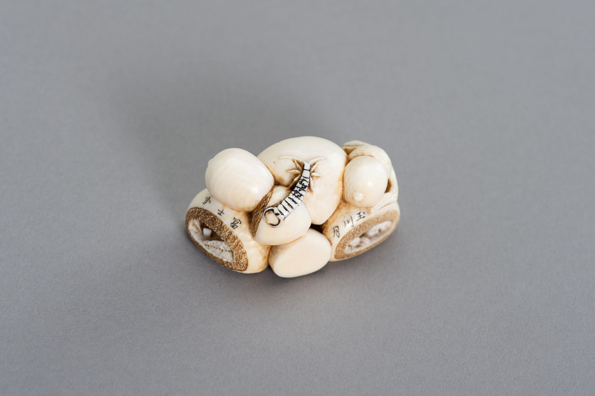 GYOKUHOSAI: AN IVORY NETSUSKE OF A GROUP OF FRUITS AND NUTS - Image 2 of 3
