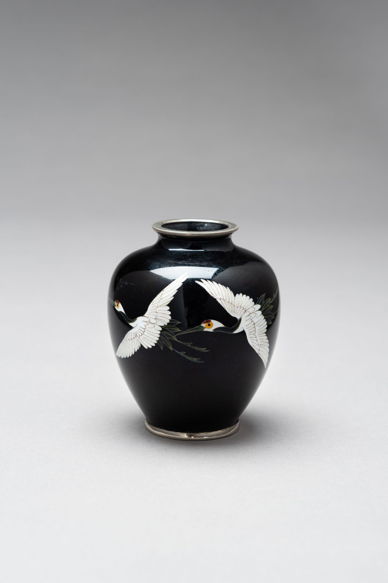 A SMALL CLOISONNE ENAMEL VASE WITH CRANES