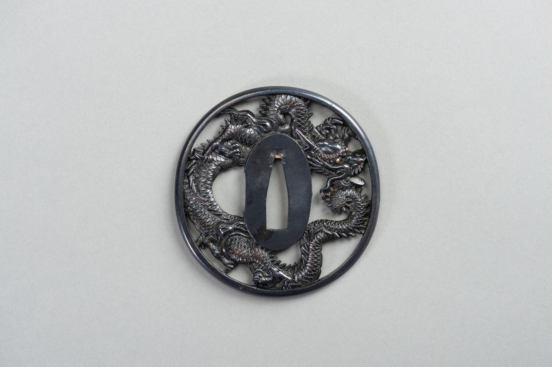 A SHAKUDO TSUBA WITH A DRAGON