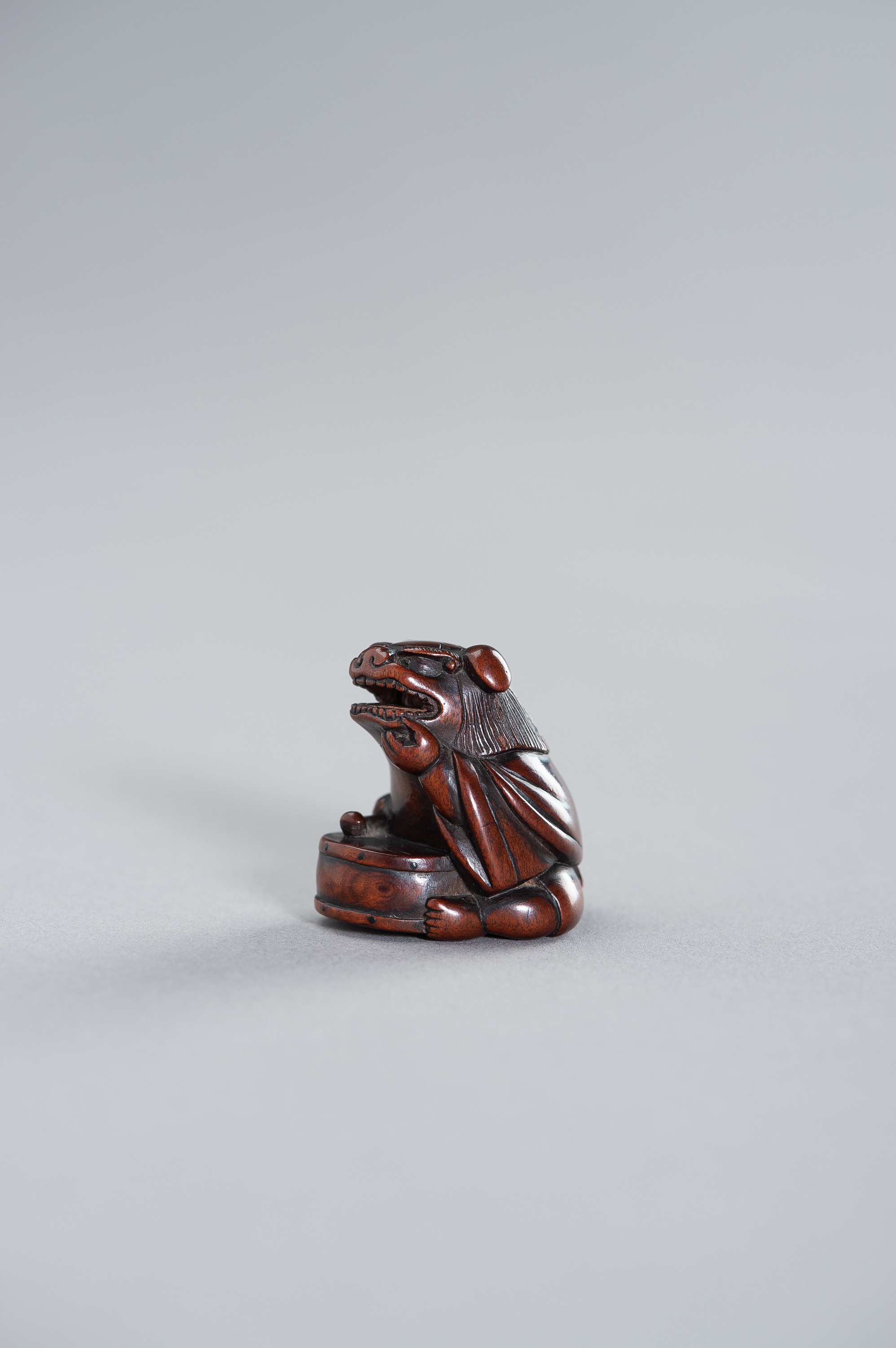 TAMETAKA: A NAGOYA SCHOOL WOOD NETSUKE OF A BOY WITH SHISHIMAI COSTUME