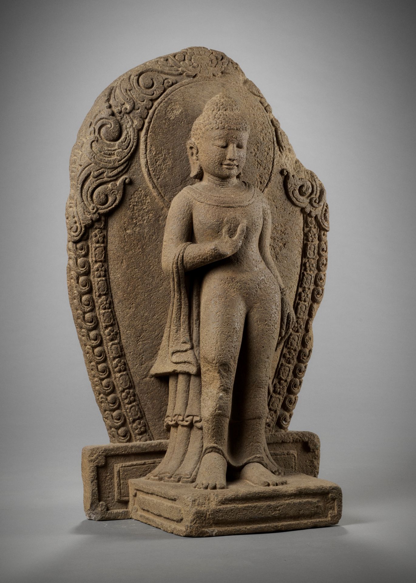 A RARE ANDESITE STATUE OF BUDDHA, CENTRAL JAVA, 9TH CENTURY