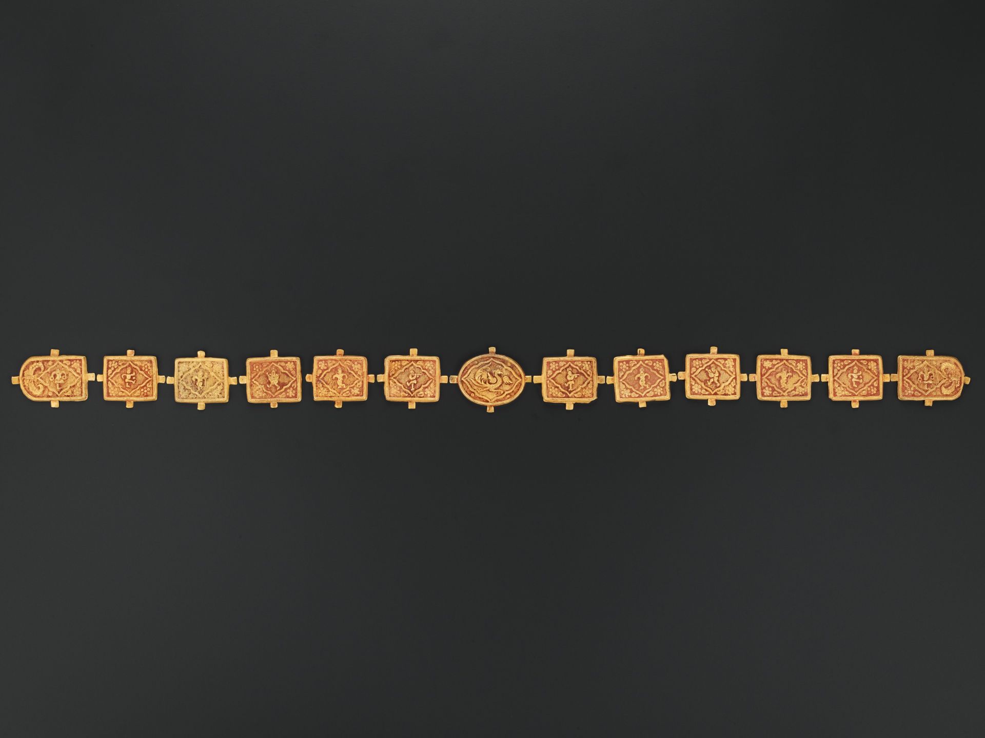 A 13-PART GOLD REPOUSSE BELT, TANG TO LIAO DYNASTY