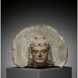 A GRAY SCHIST MAITREYA HEAD AND HALO, GANDHARA