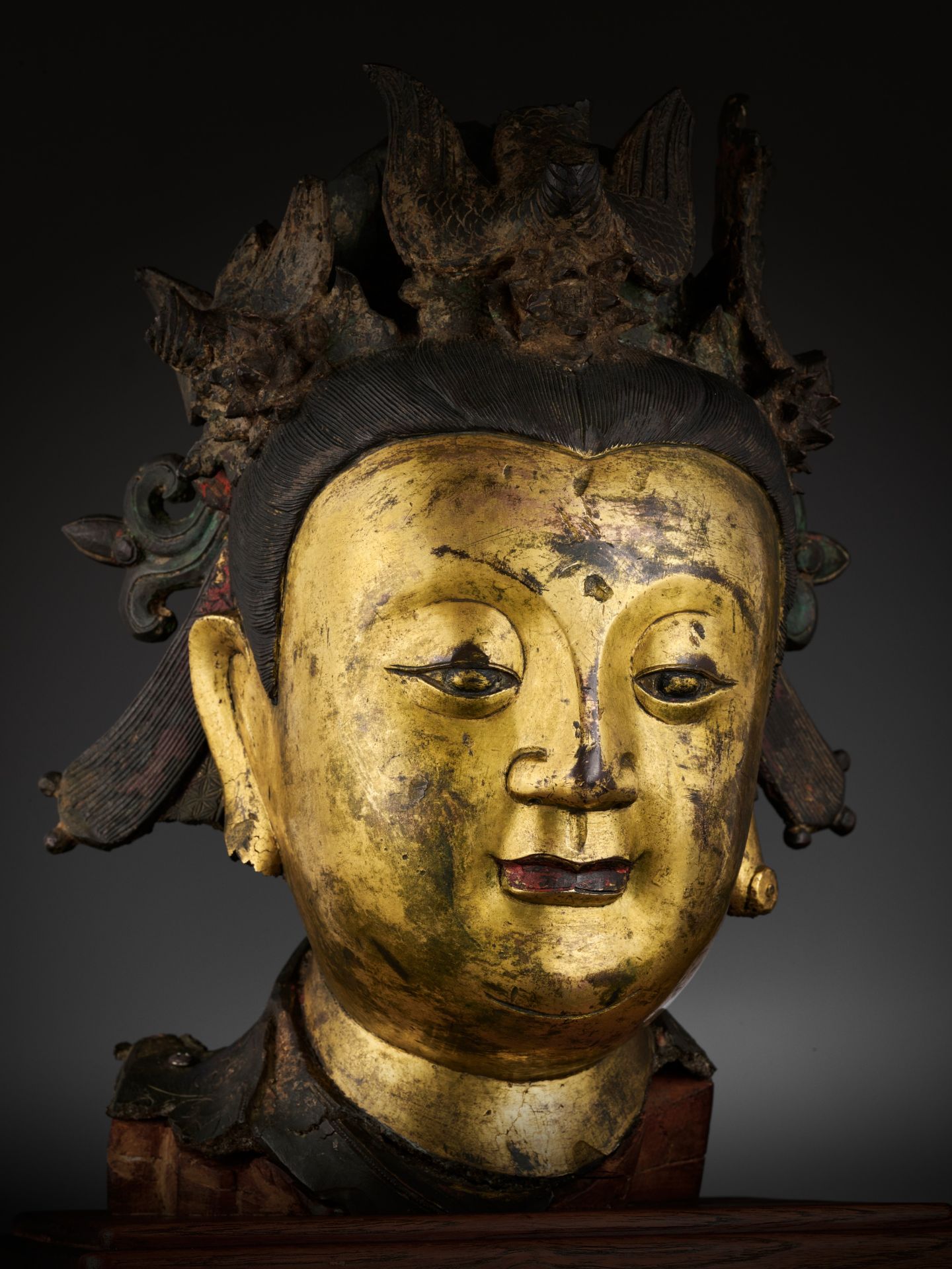 AN IMPORTANT GILT-BRONZE HEAD OF BIXIA YUANJUN, THE SOVEREIGN OF THE COLORED CLOUDS OF DAWN, MING