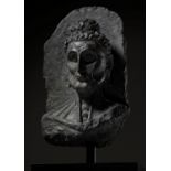 A SCHIST HEAD OF THE EMACIATED BUDDHA, GANDHARA