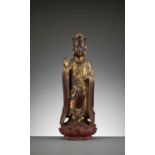 A RED AND GILT-LACQUERED WOOD FIGURE OF GUANYIN, 17TH - 18TH CENTURY