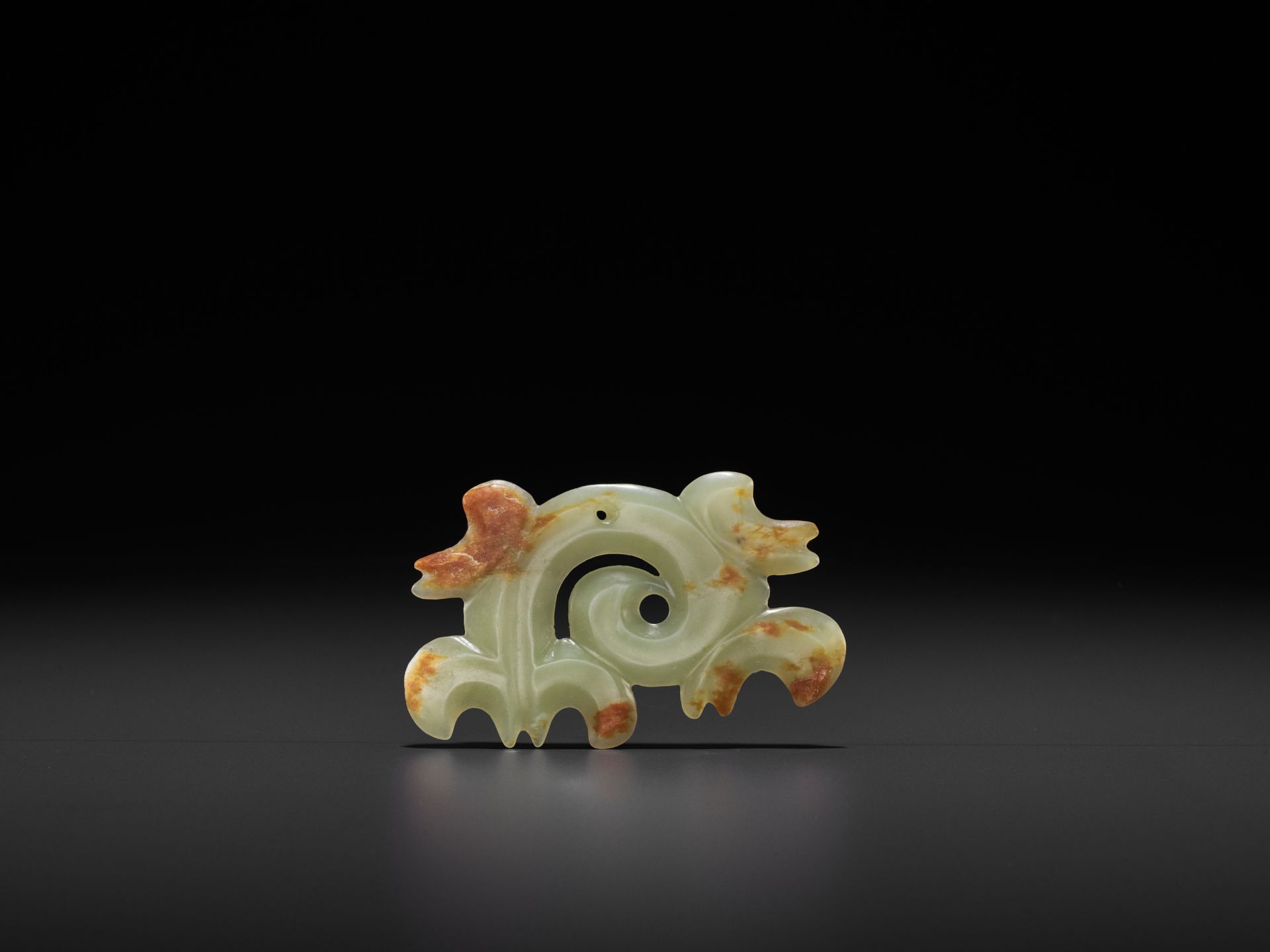 A RARE YELLOW AND RUSSET JADE 'CLOUD-SCROLL' PENDANT, HONGSHAN CULTURE