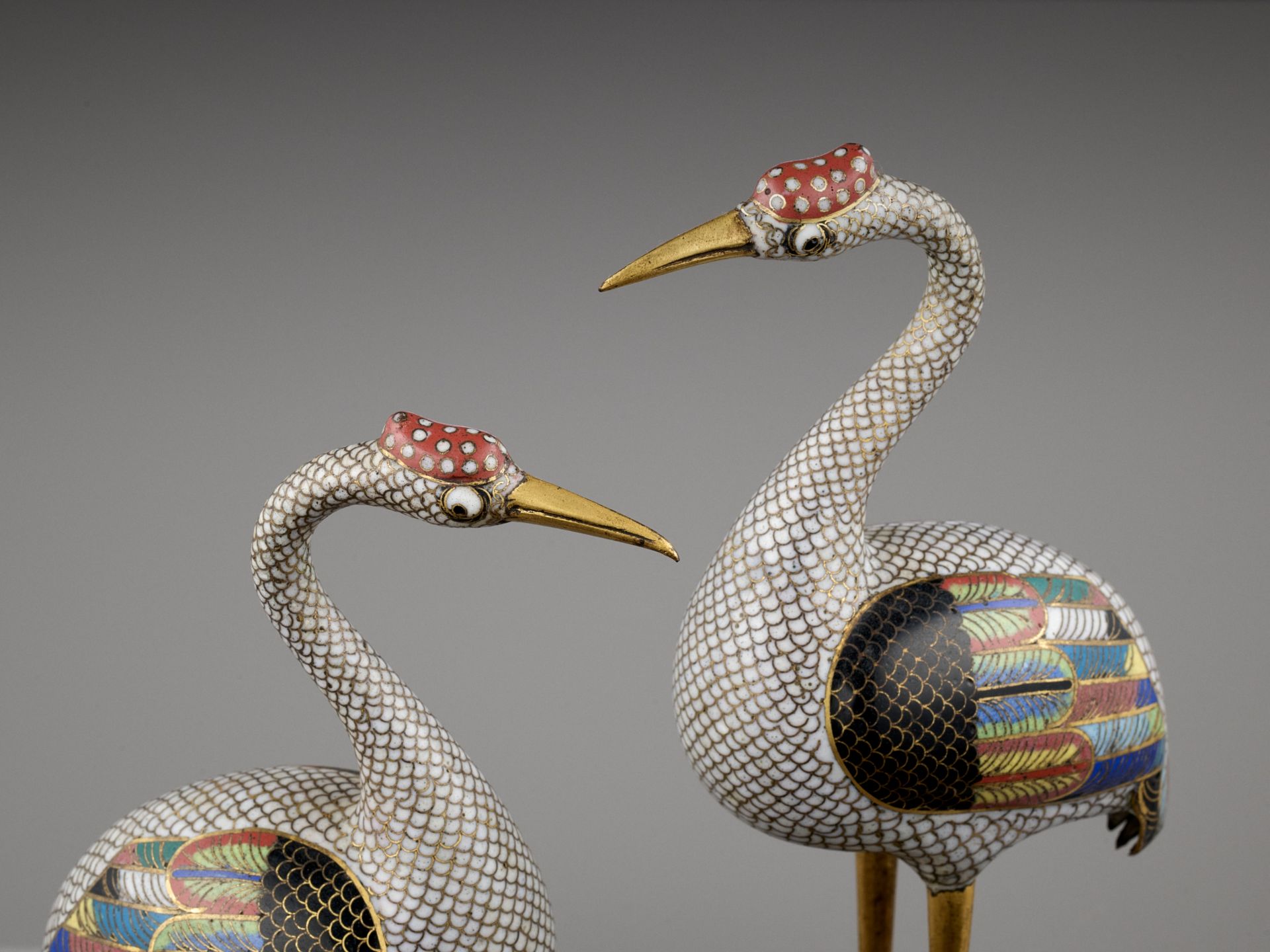 A PAIR OF GILT BRONZE AND CLOISONNE ENAMEL FIGURES OF CRANES, QING DYNASTY