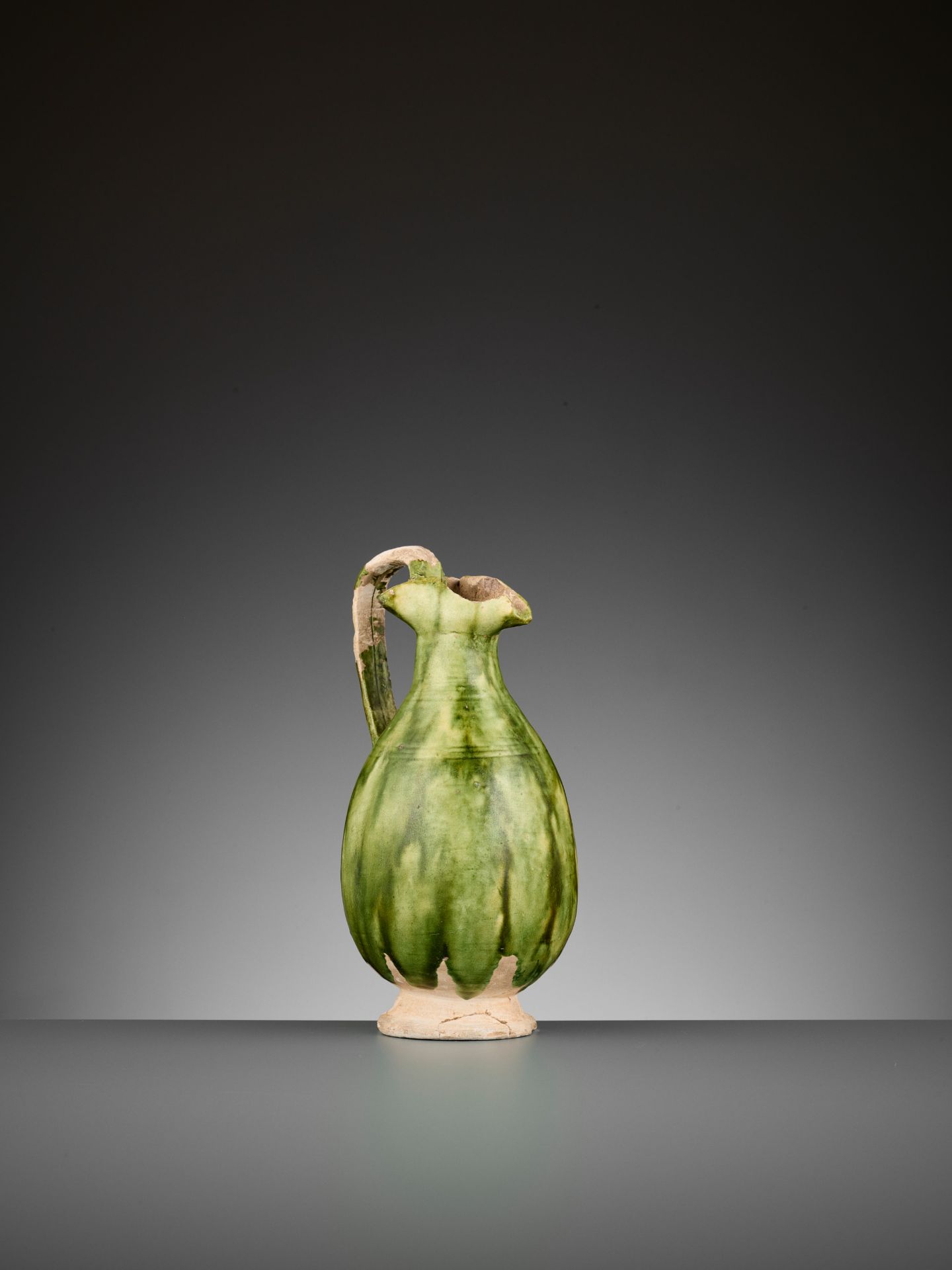 A GREEN-GLAZED EWER, TANG DYNASTY