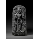 A VERY LARGE BLACK STONE STELE OF SURYA, PALA PERIOD