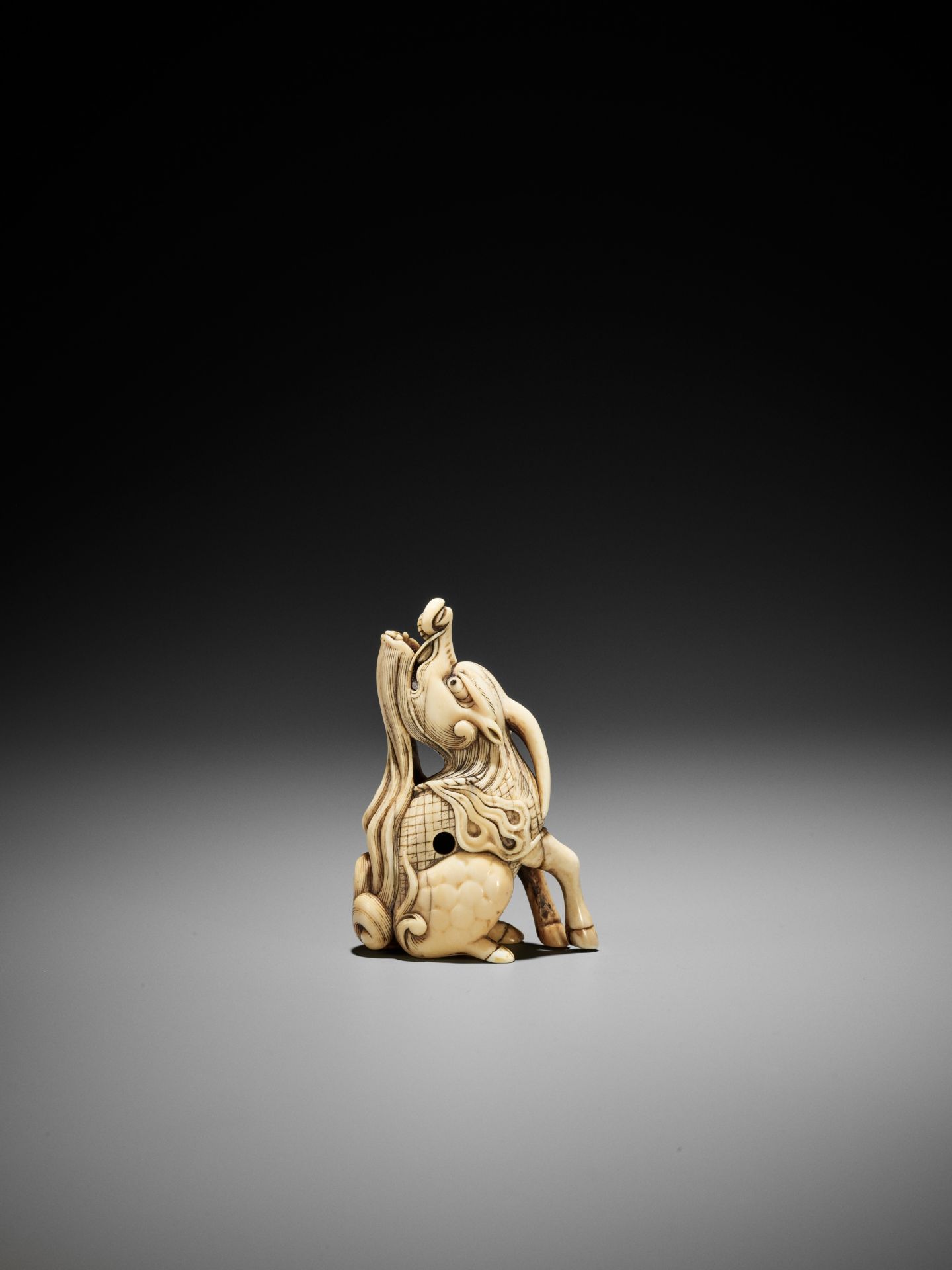 A POWERFUL IVORY NETSUKE OF A BAYING KIRIN, ATTRIBUTED TO MITSUHARU - Image 4 of 12