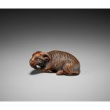 A FINE KYOTO SCHOOL WOOD NETSUKE OF A RECUMBENT GOAT