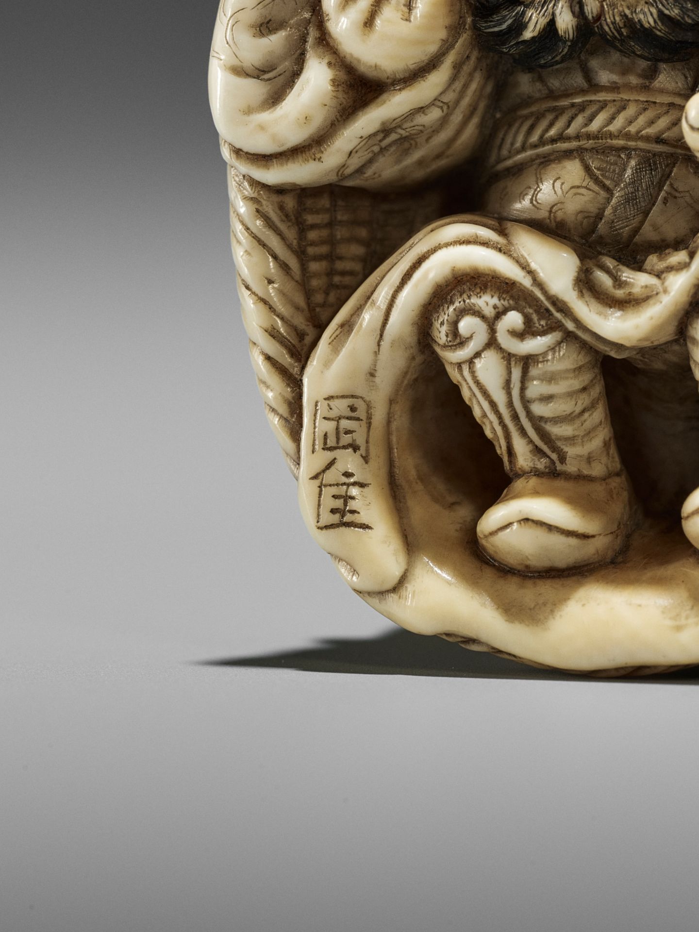 OKATORI: AN IVORY NETSUKE OF AN ONI TRAPPING SHOKI - Image 11 of 12