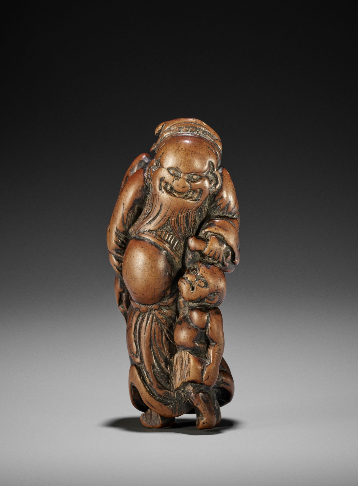 A LARGE WOOD NETSUKE OF SHOKI AND ONI