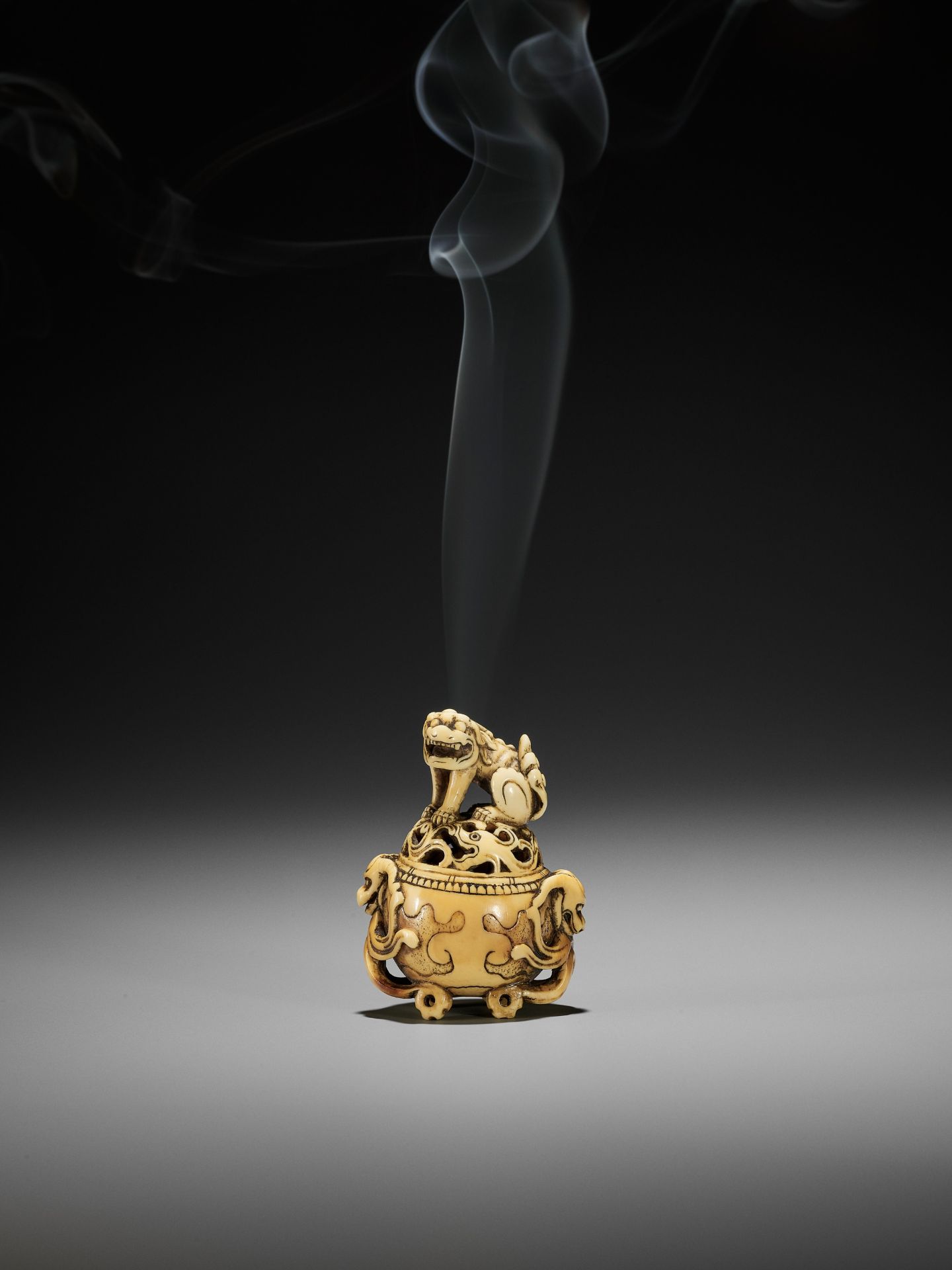 A RARE IVORY NETSUKE OF A KORO (INCENSE BURNER) WITH SHISHI - Image 2 of 10