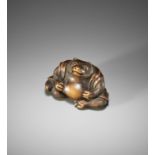 YASUSADA SHUZAN: A FINE WOOD NETSUKE OF A TANUKI