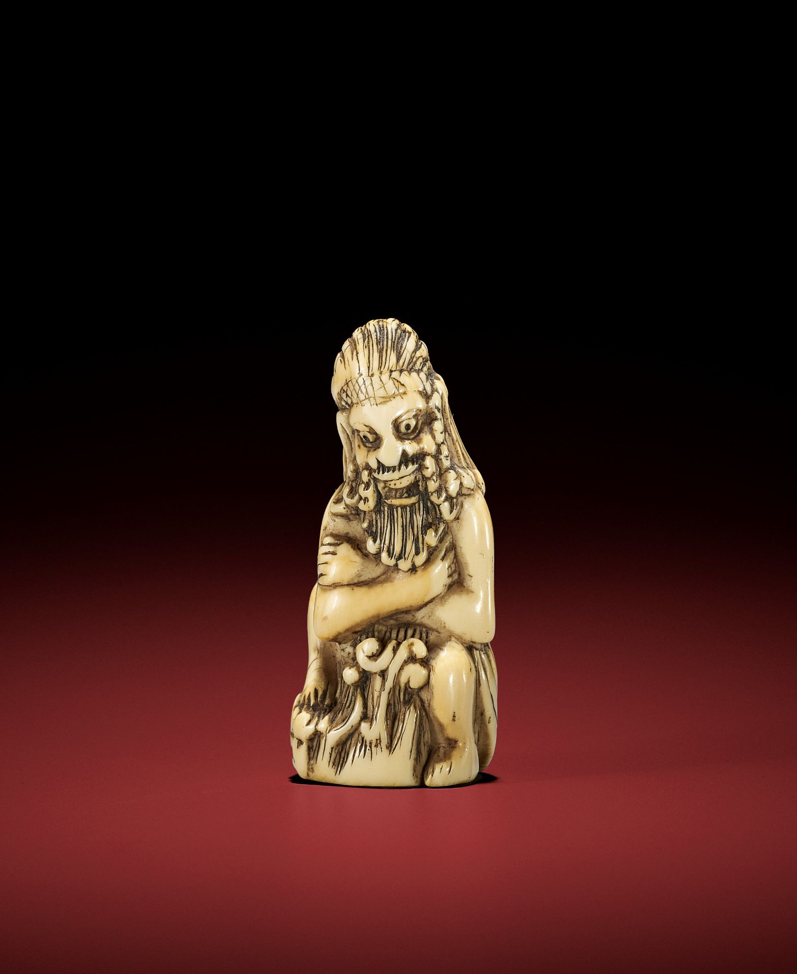 A RARE IVORY NETSUKE OF A FOREIGN DEVIL