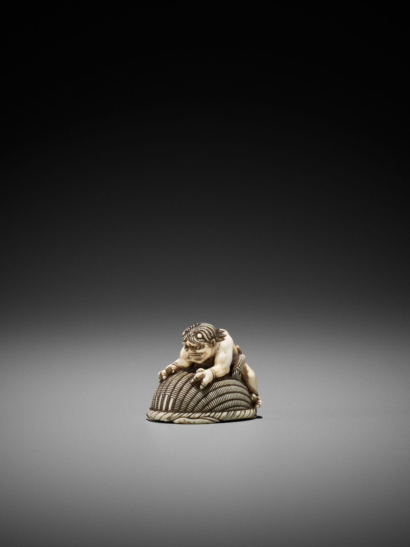 OKATORI: AN IVORY NETSUKE OF AN ONI TRAPPING SHOKI - Image 5 of 12