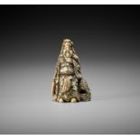 AN IVORY NETSUKE OF KAN'U LEANING AGAINST A ROCK