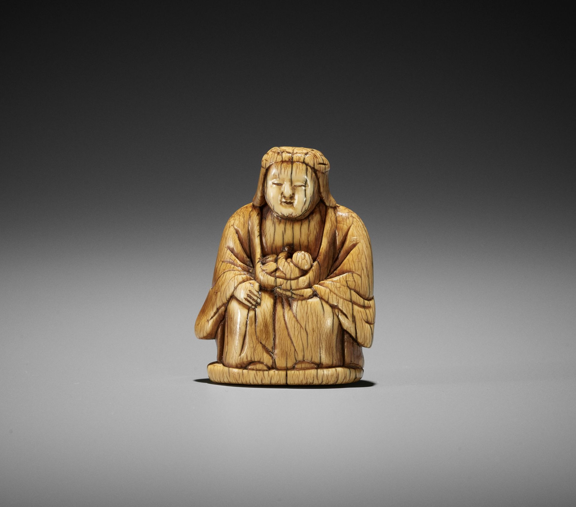 A RARE AND EARLY IVORY NETSUKE OF KARITEIMO (HARITI)