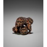 ISSAI: A FINE WOOD NETSUKE OF TWO FIGHTING SHISHI