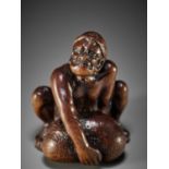 GESSHO: A SUPERB WOOD NETSUKE OF A STONE LIFTER