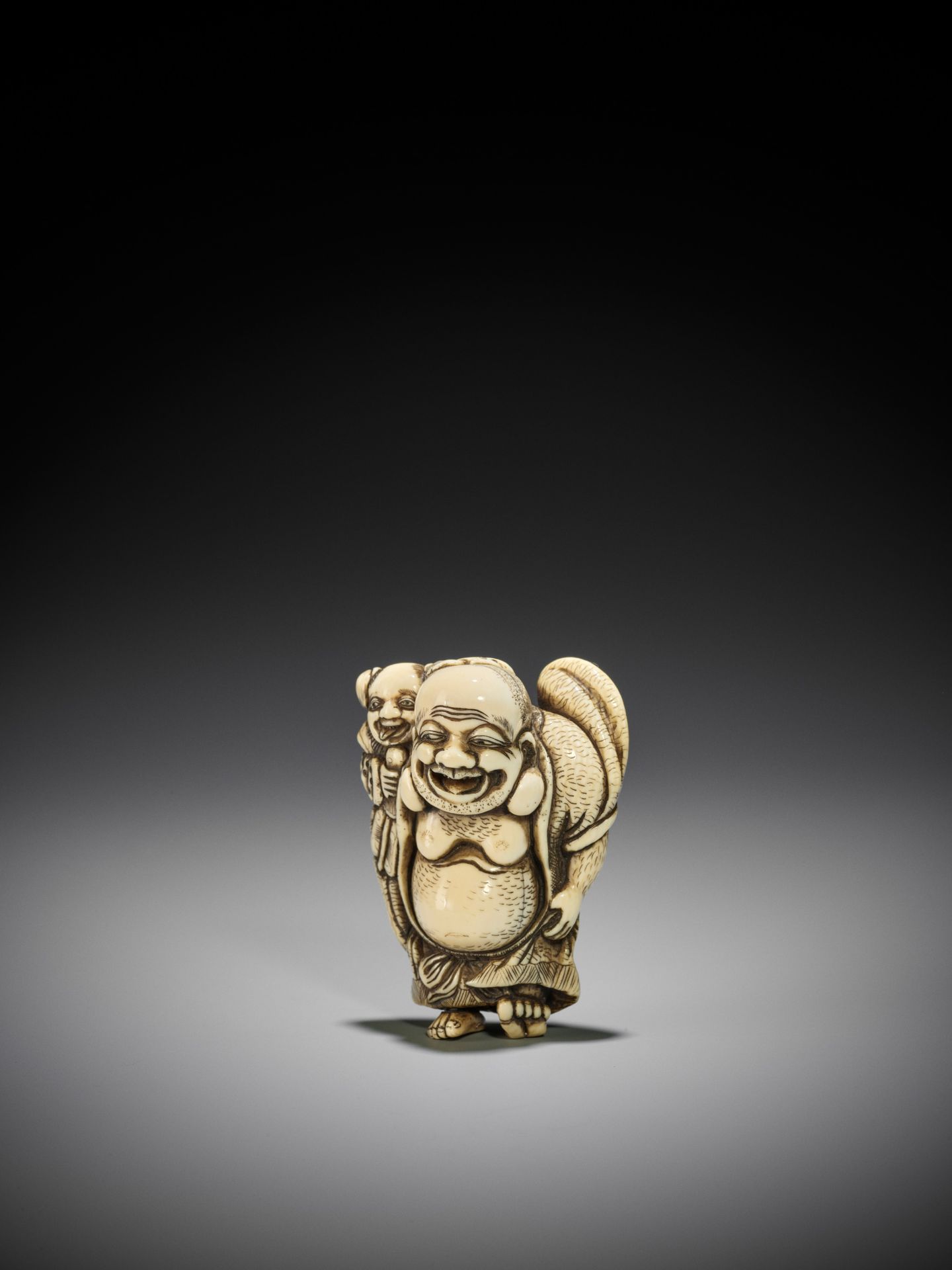 TOZAN: A SUPERB AND LARGE IVORY NETSUKE OF HOTEI WITH KARAKO - Image 14 of 16