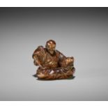 BANRYUSAI: A RARE WOOD NETSUKE OF A HANNYA MASK CARVER