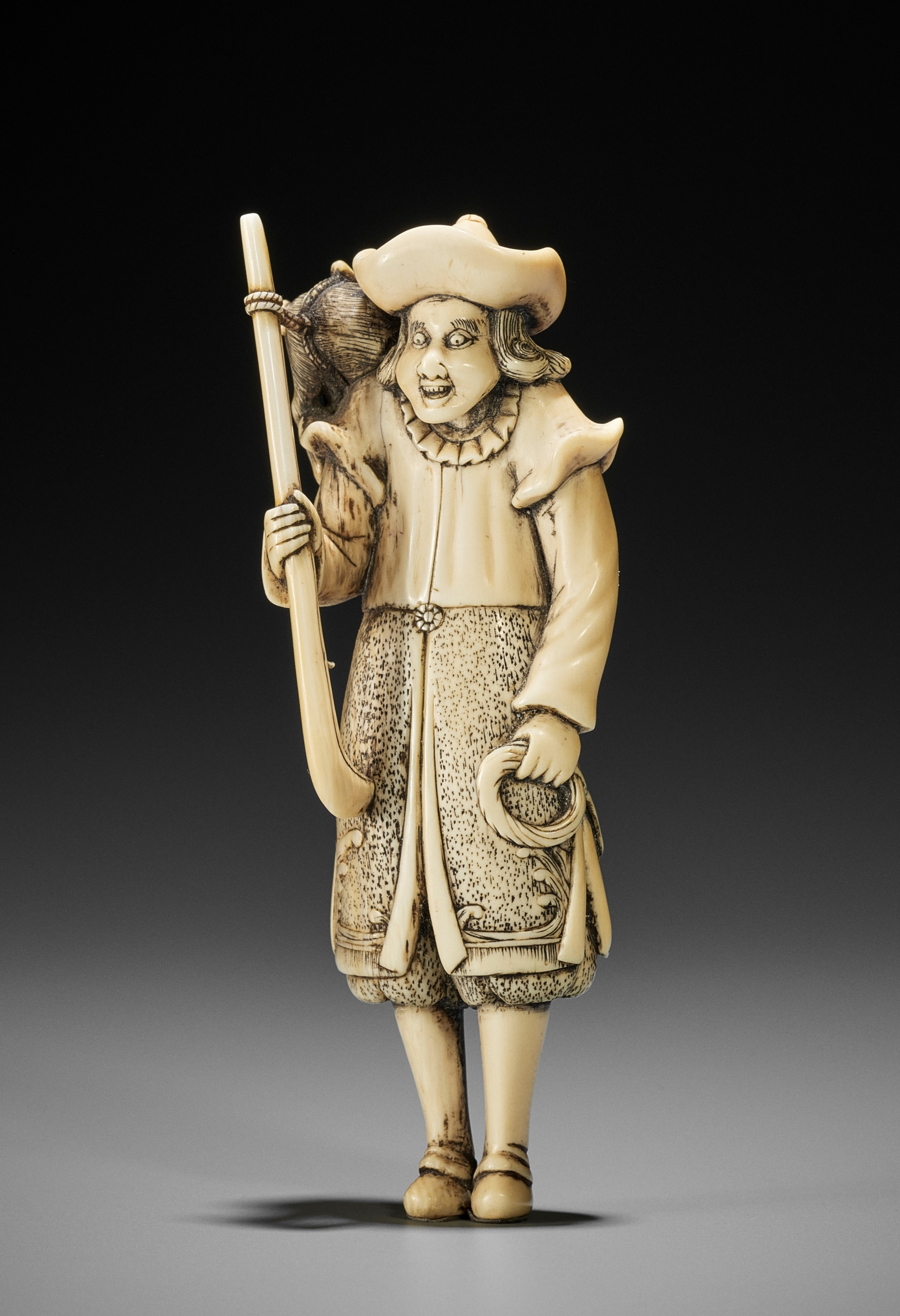 A SUPERB AND LARGE IVORY NETSUKE OF A DUTCHMAN