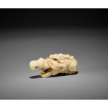 A RARE MARINE IVORY NETSUKE OF A BAKU HEAD