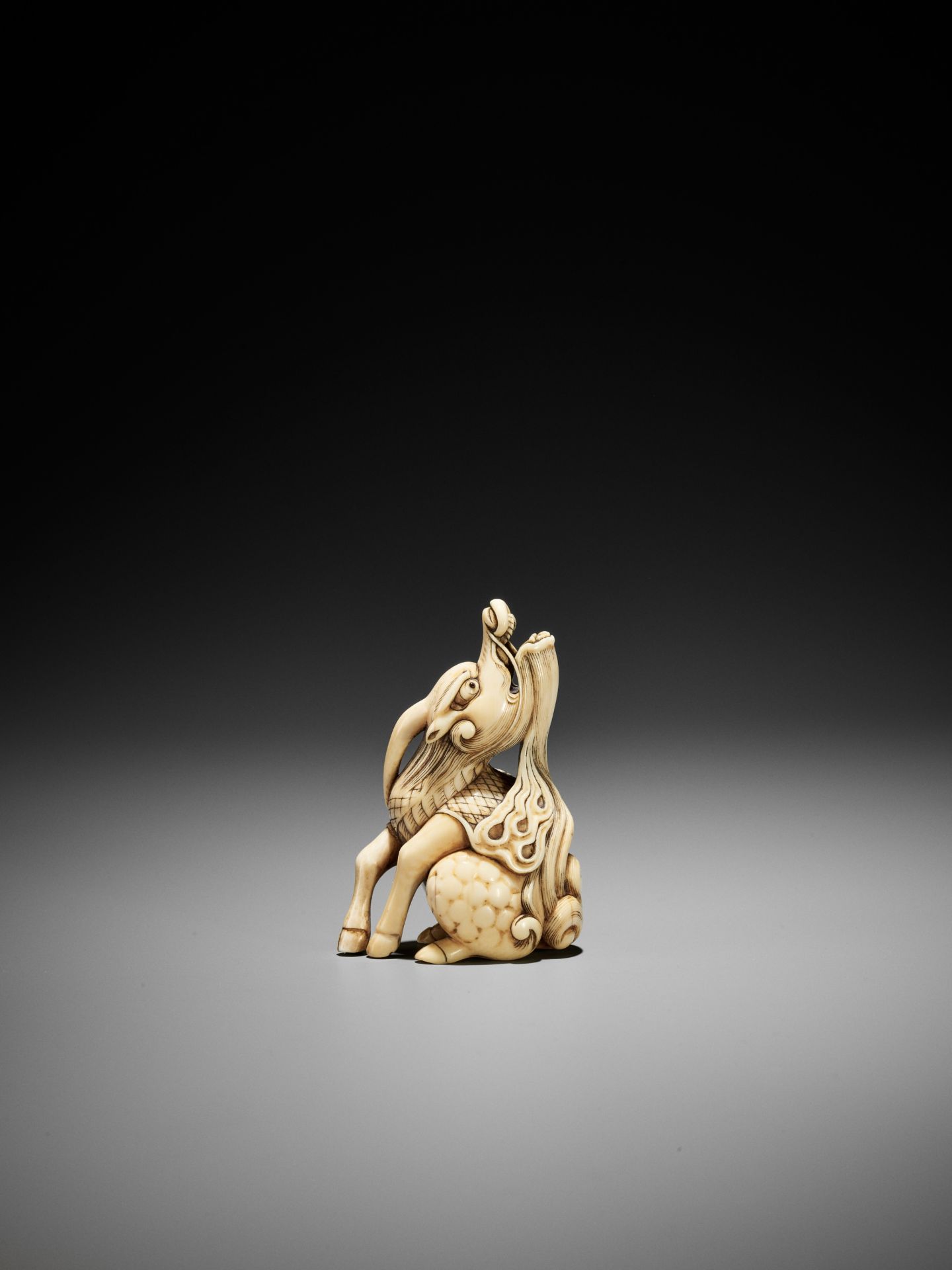 A POWERFUL IVORY NETSUKE OF A BAYING KIRIN, ATTRIBUTED TO MITSUHARU - Image 6 of 12