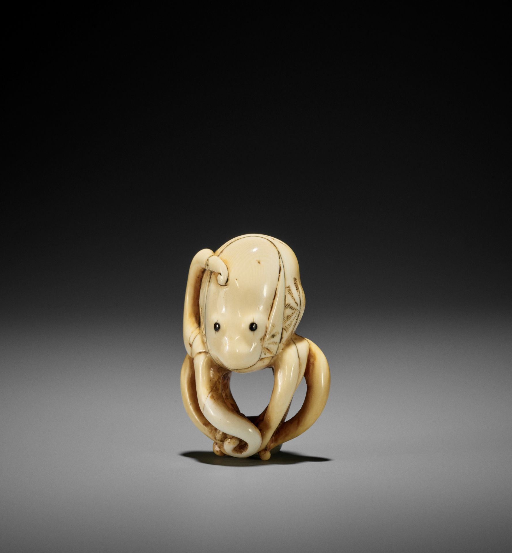 A GOOD IVORY NETSUKE OF AN OCTOPUS