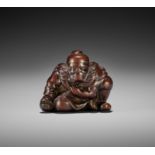 JUGYOKU I: A RARE AND SUPERB WOOD NETSUKE OF SHOKI WITH A BAG OF ONI