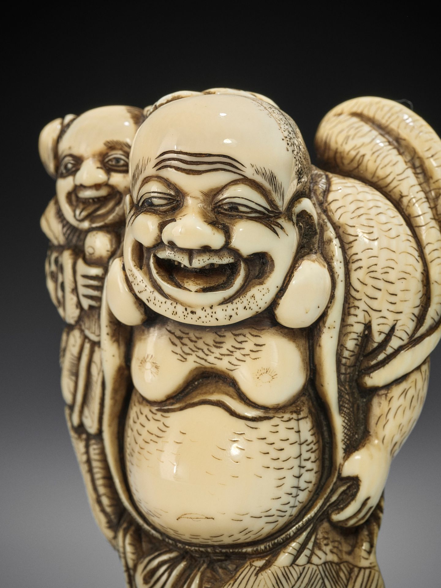 TOZAN: A SUPERB AND LARGE IVORY NETSUKE OF HOTEI WITH KARAKO - Image 5 of 16