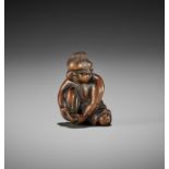 A CHARMING OLD WOOD NETSUKE OF OKAME CLIPPING HER TOENAILS