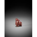 A RARE NEGORO LACQUERED WOOD NETSUKE OF A MONKEY WITH PEACH