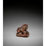 A GOOD WOOD NETSUKE OF A SHISHI