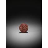 A FINE TSUISHU (CARVED RED LACQUER) MANJU NETSUKE WITH LILIES