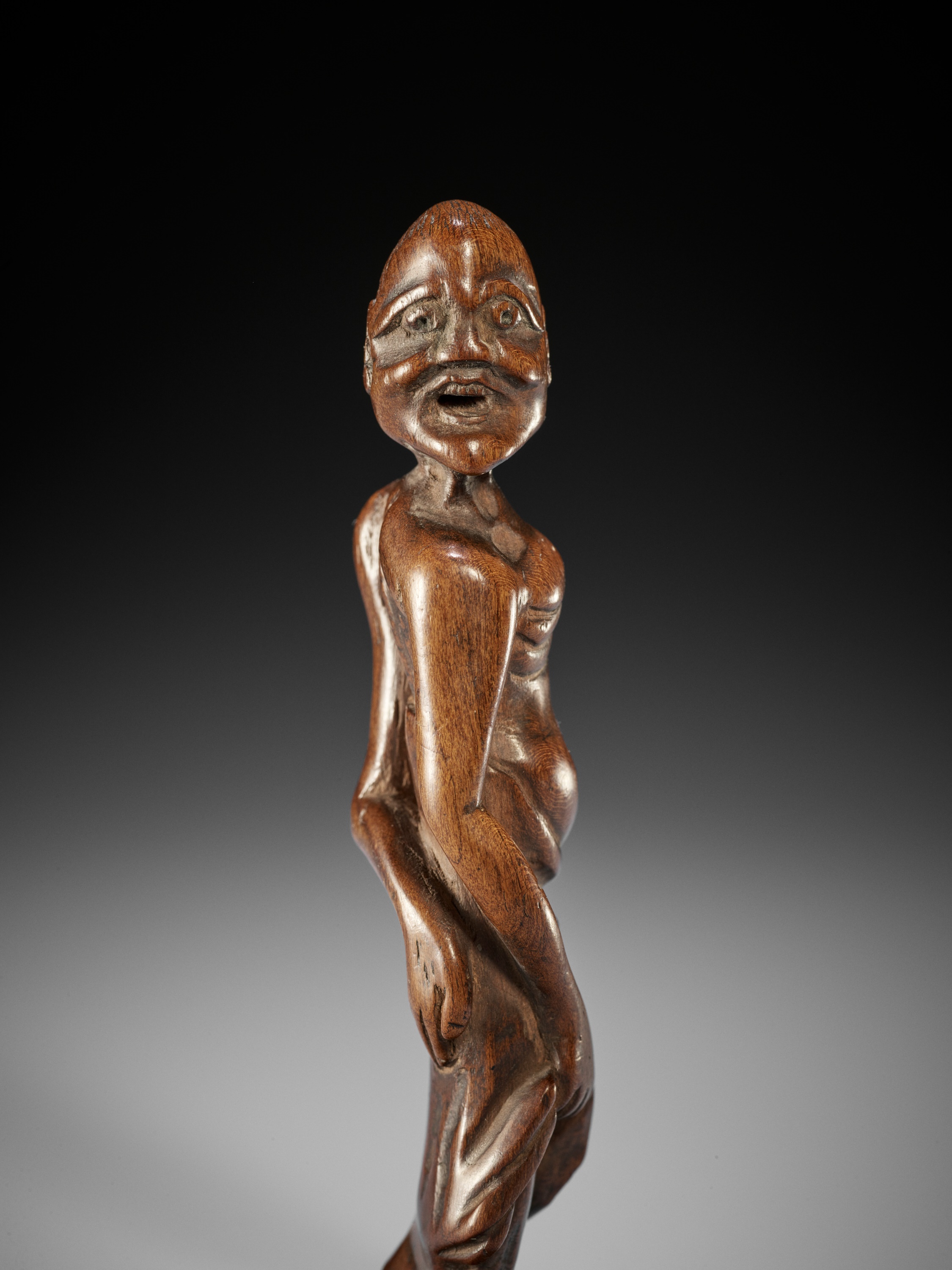 A RARE TALL WOOD NETSUKE OF TENAGA