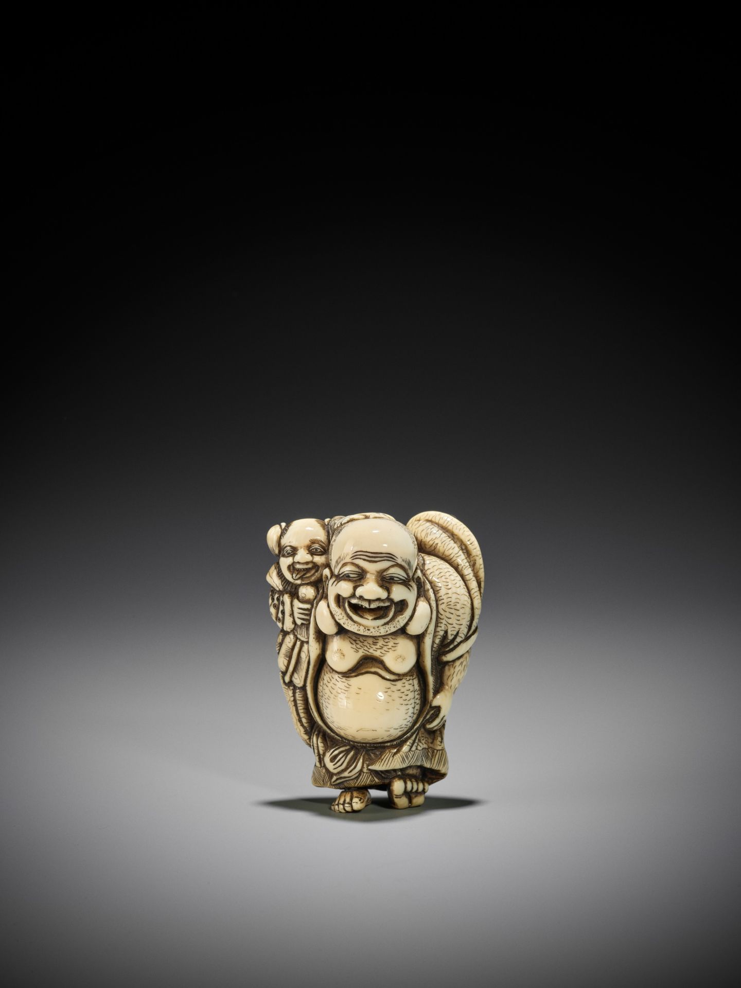 TOZAN: A SUPERB AND LARGE IVORY NETSUKE OF HOTEI WITH KARAKO - Image 13 of 16