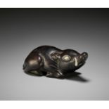 A LARGE AND OLD DARK WOOD NETSUKE OF A RECUMBENT BOAR