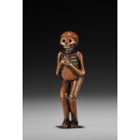 A RARE WOOD NETSUKE OF A SKELETON