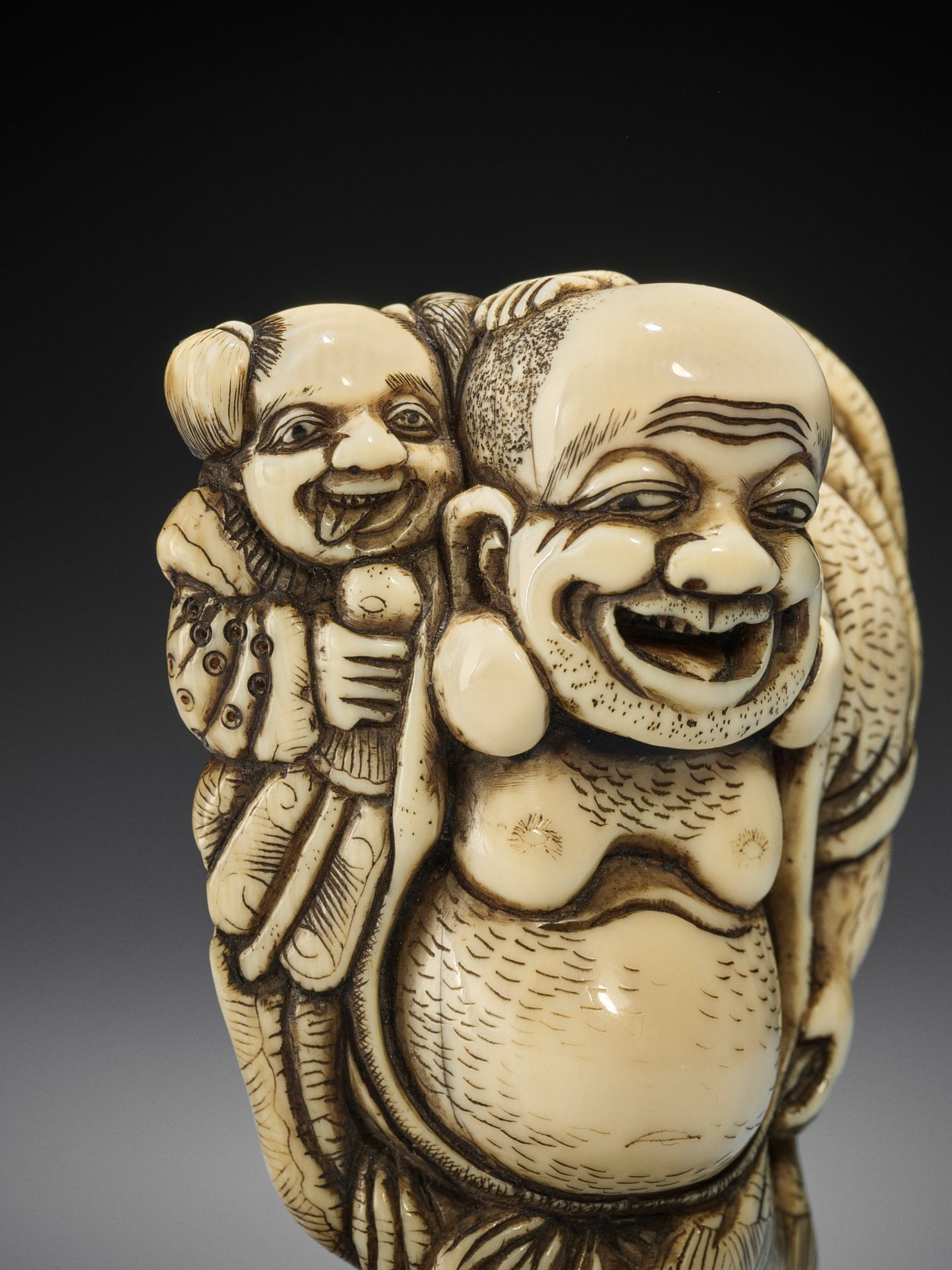 TOZAN: A SUPERB AND LARGE IVORY NETSUKE OF HOTEI WITH KARAKO - Image 3 of 16