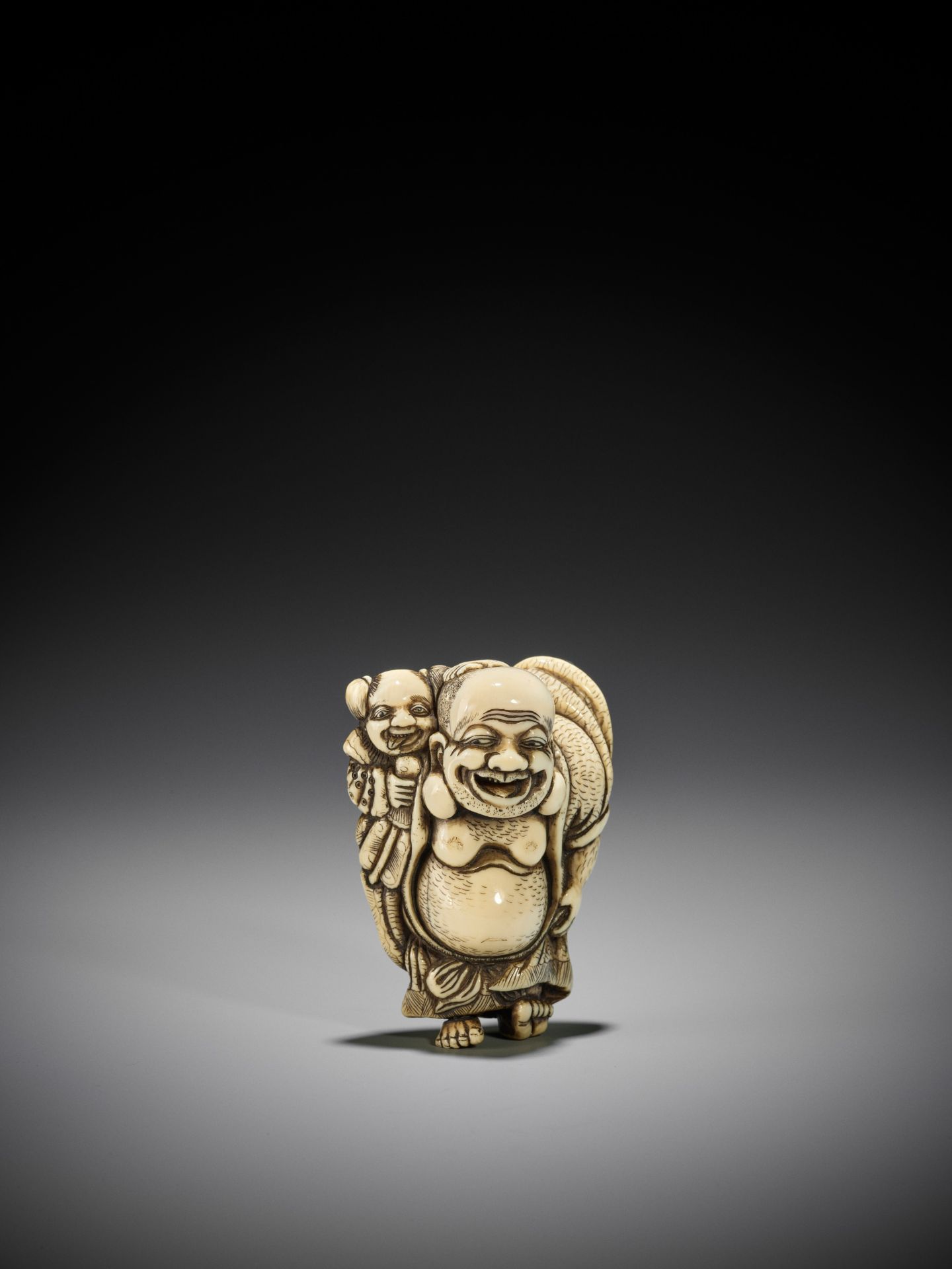 TOZAN: A SUPERB AND LARGE IVORY NETSUKE OF HOTEI WITH KARAKO - Image 12 of 16