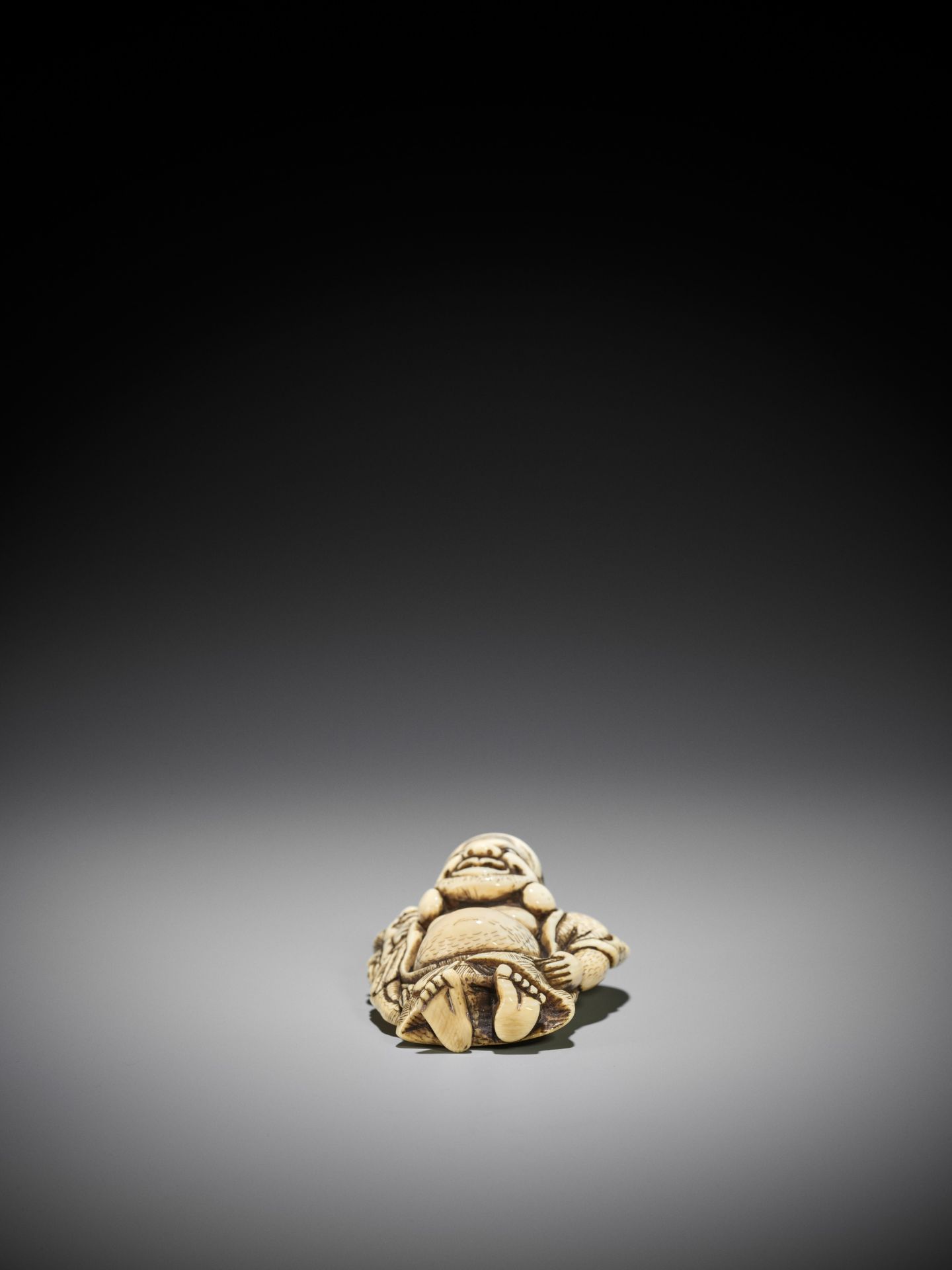 TOZAN: A SUPERB AND LARGE IVORY NETSUKE OF HOTEI WITH KARAKO - Image 15 of 16