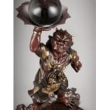 A LARGE PARCEL-GILT BRONZE MIYAO STYLE FIGURE OF AN ONI WITH ROCK CRYSTAL BALL