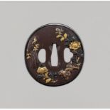 A FINE GOTO SCHOOL IRON TSUBA WITH SHISHI AND PEONIES