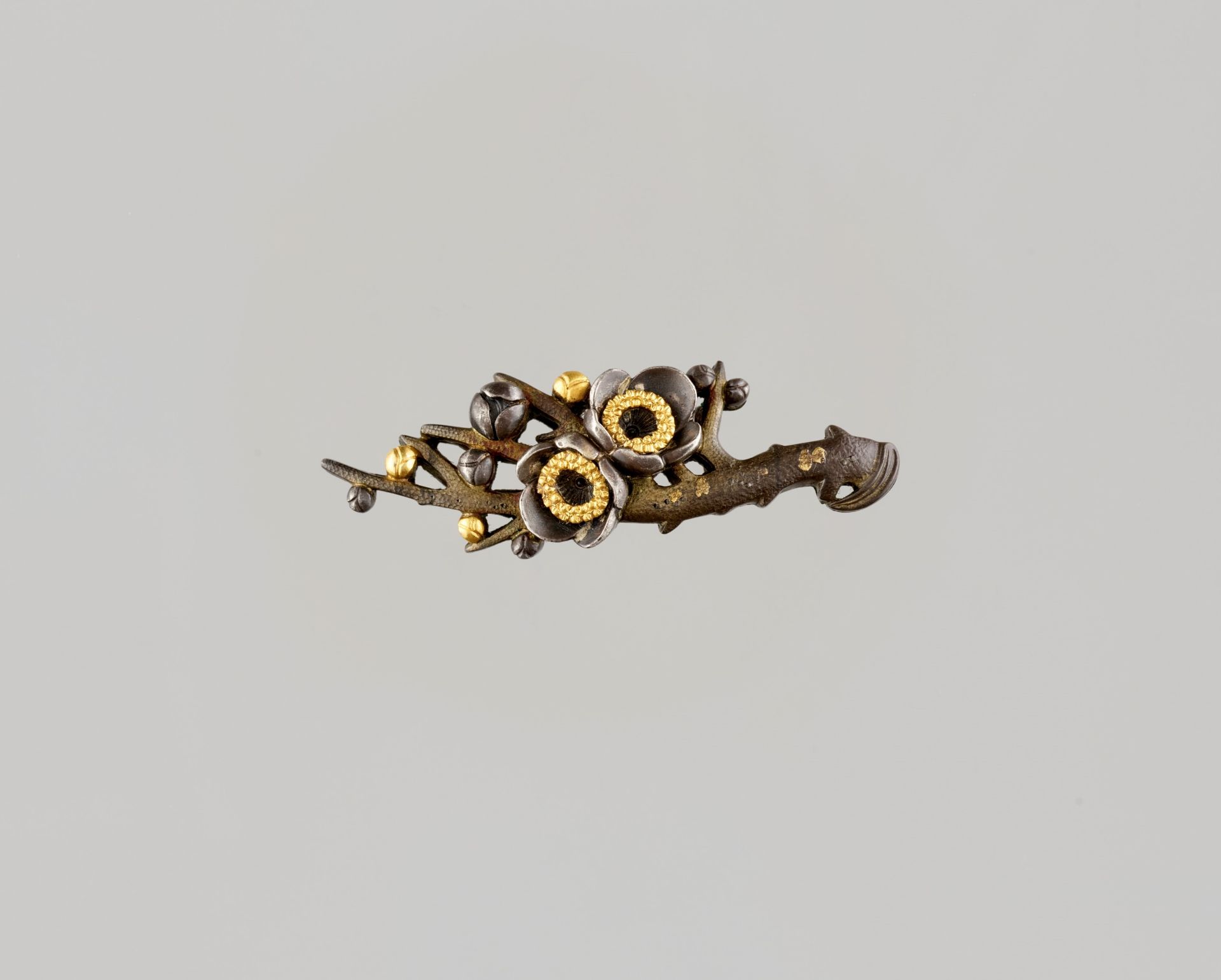 KATSUHIRA: A FINE SHIBUICHI OBIDOME (SASH CLIP) DEPICTING A PRUNUS BRANCH